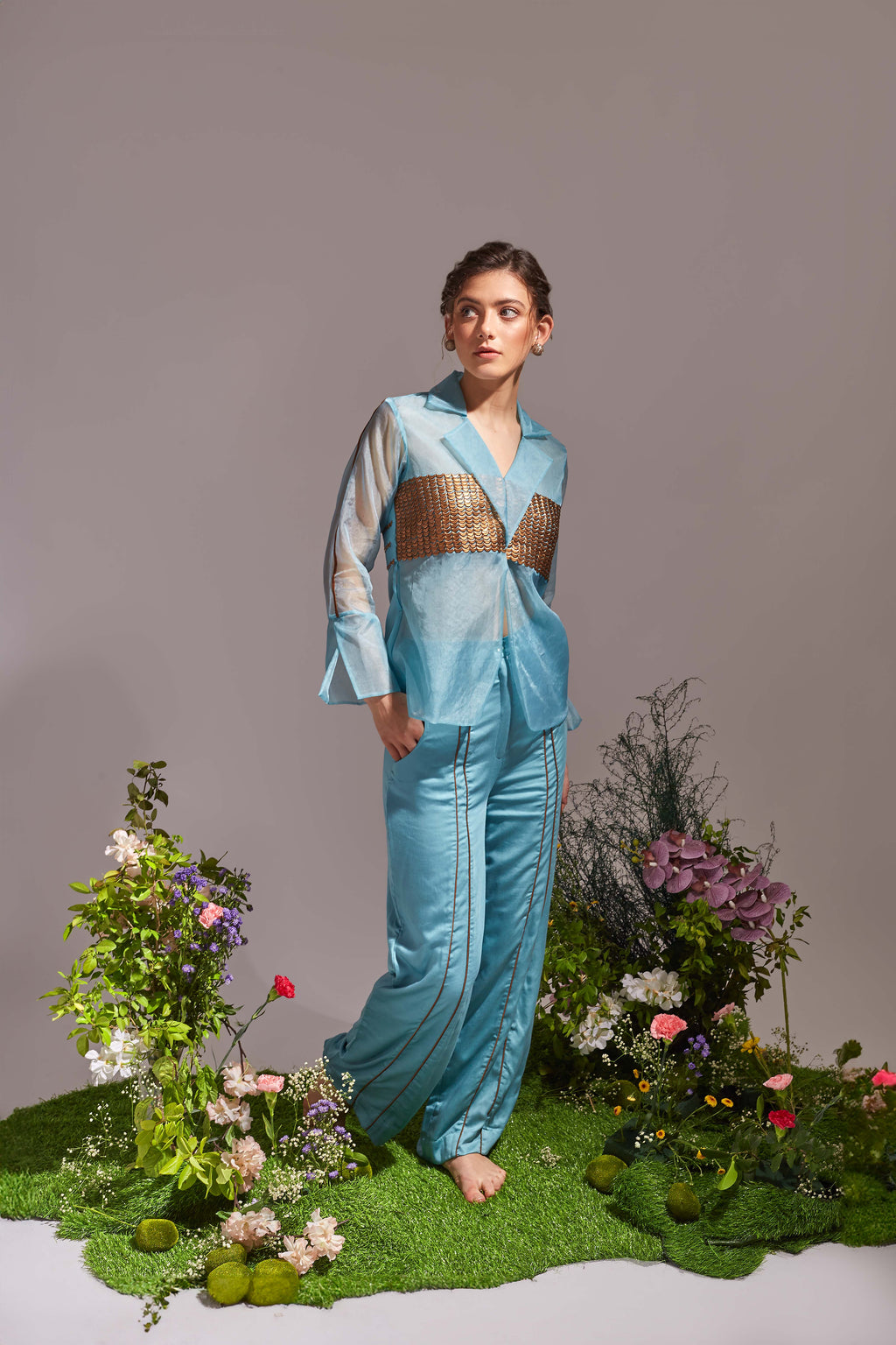 A cyan blue ethereal sheer jacket with moon sequins and contrast-piping detailed pants, paired with a color-block tie-up belt at the waist.